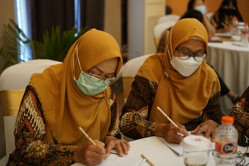 a couple of women sitting at a table