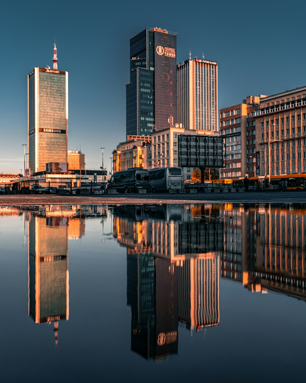 a large body of water with buildings in the background