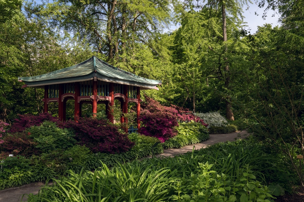 a gazebo in the middle of a lush green park