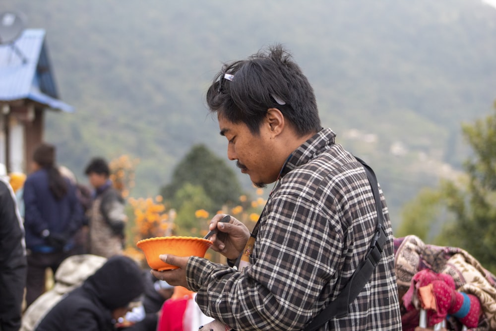 a man holding a bowl of food in his hands
