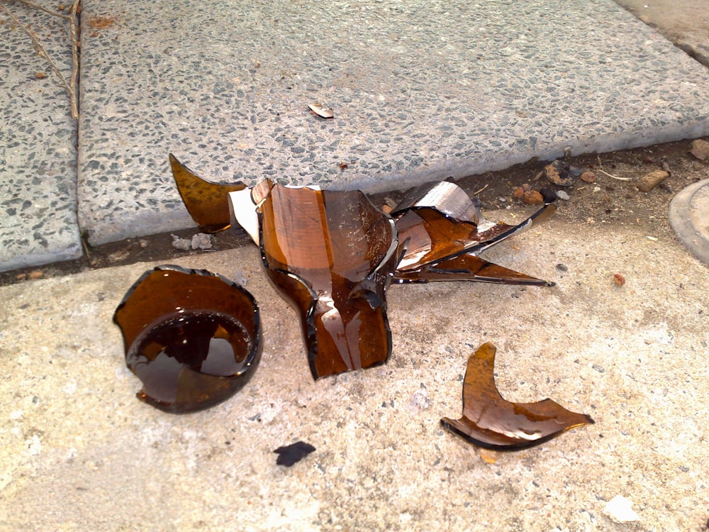 a broken piece of glass sitting on the ground