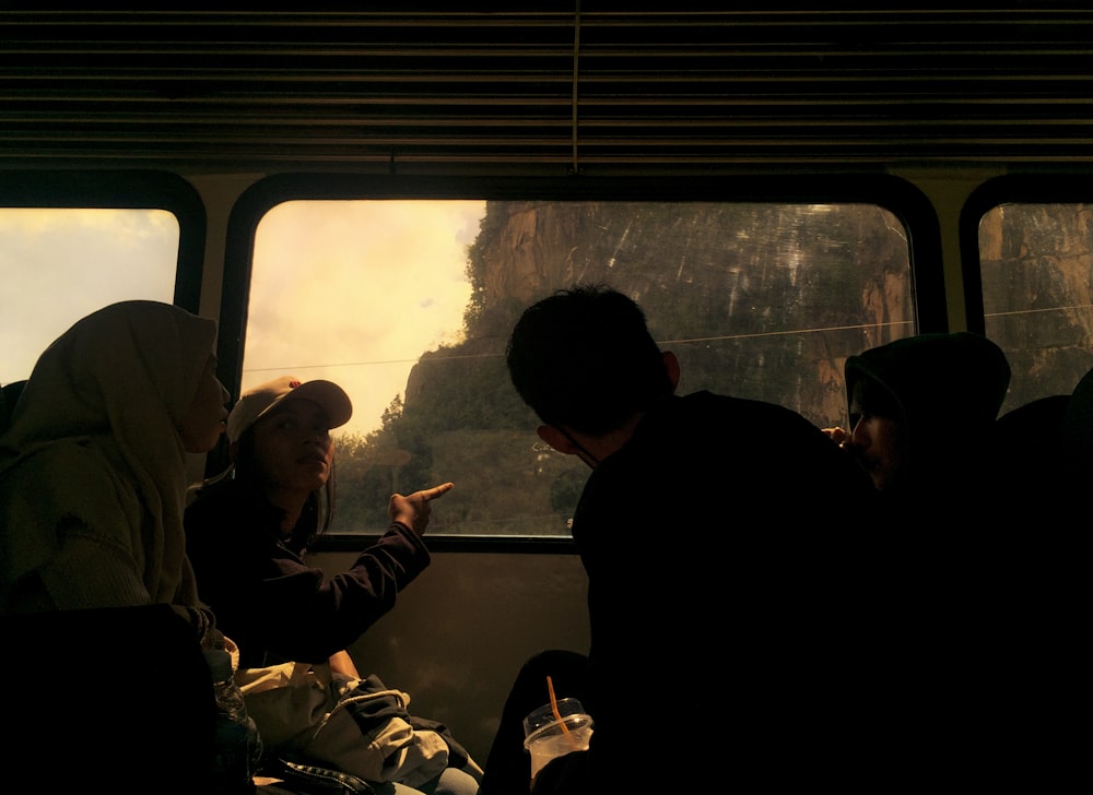 a group of people sitting on a bus next to each other