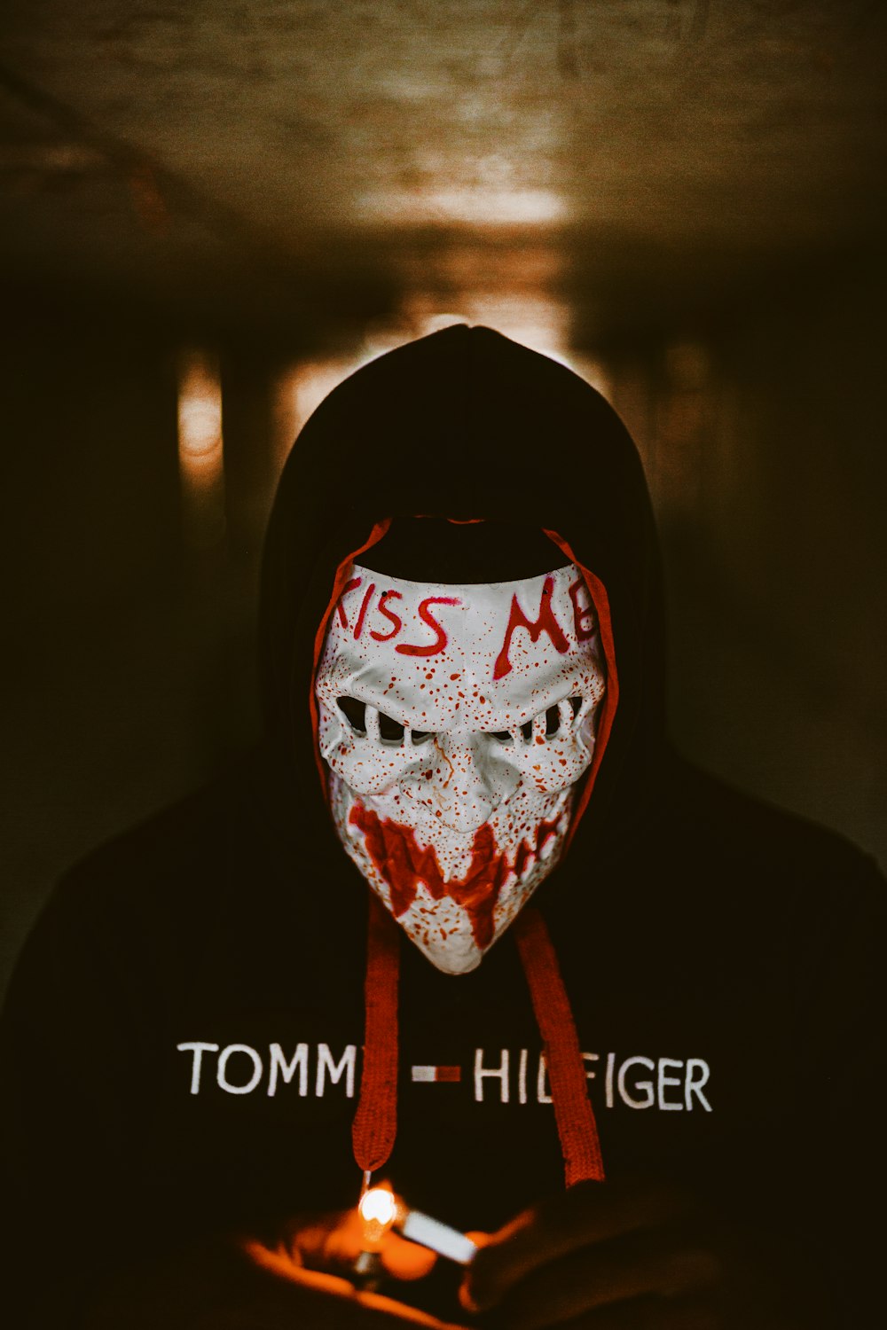 a person wearing a mask and holding a cell phone