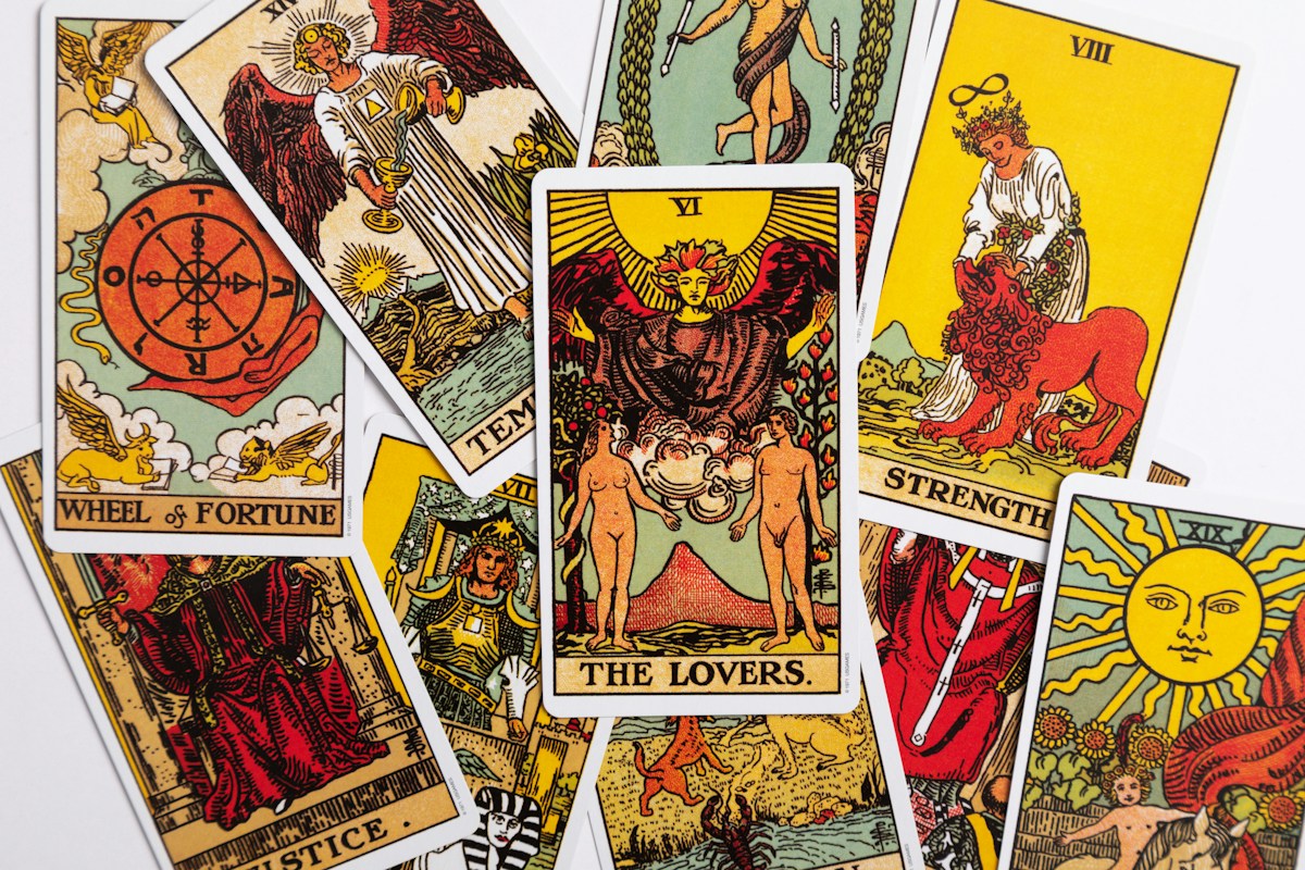 A close-up arrangement of traditional tarot cards on a white background.