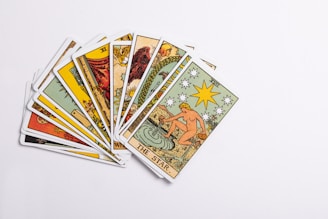 A collection of tarot cards spread on a table.