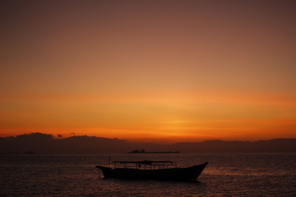 a boat floating on top of a large body of water