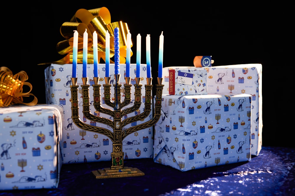 a lit menorah and gift boxes on a table