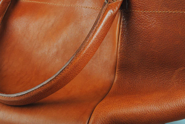Brown leather handbag with a long strap