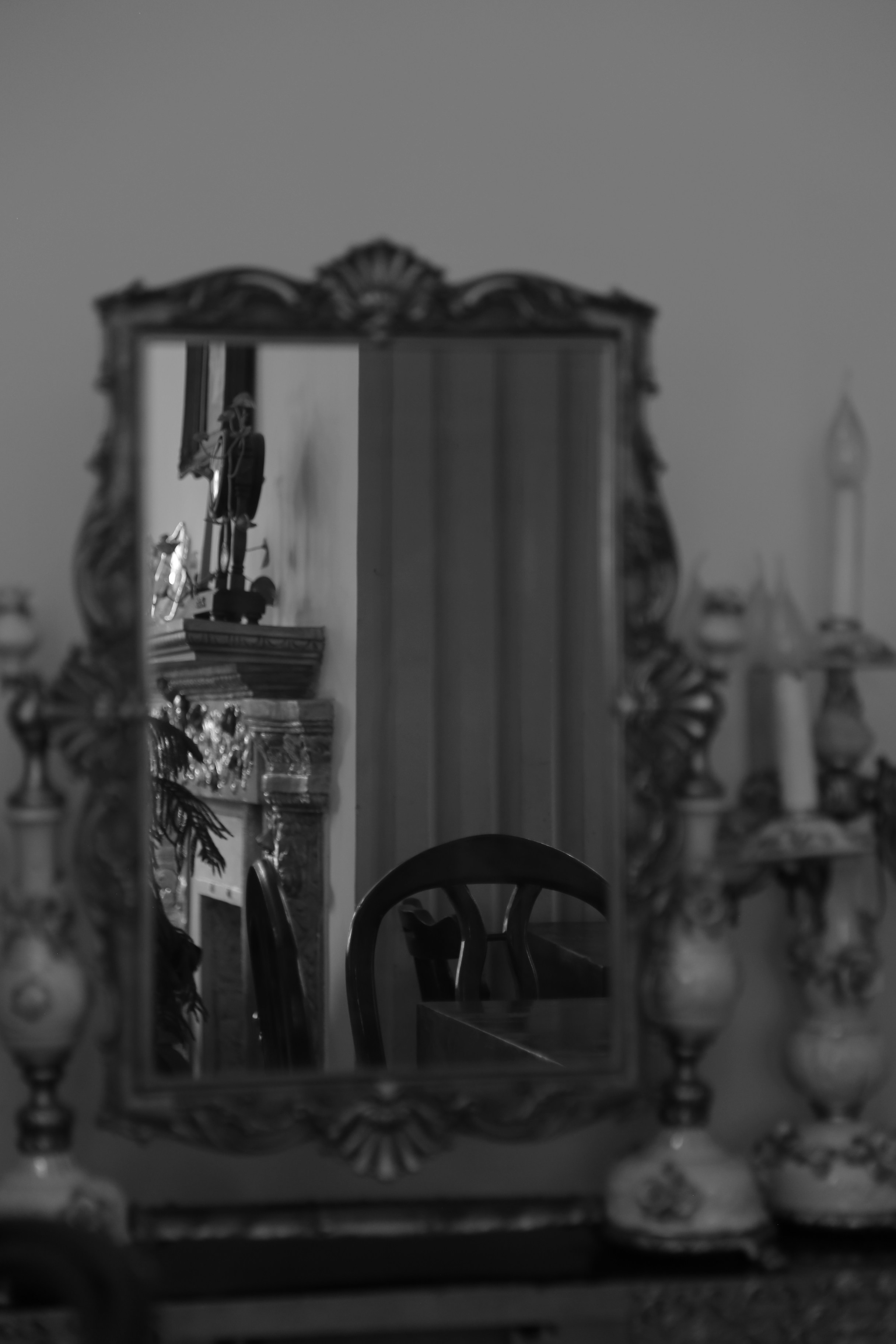 A mirror sitting on top of a dresser next to a table photo Free