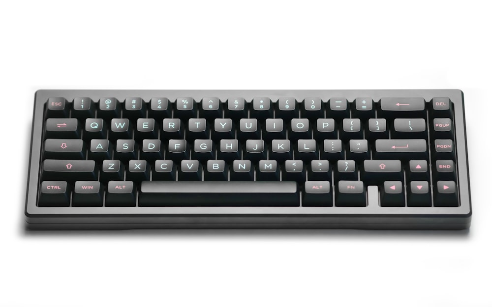 a black and silver keyboard on a white surface