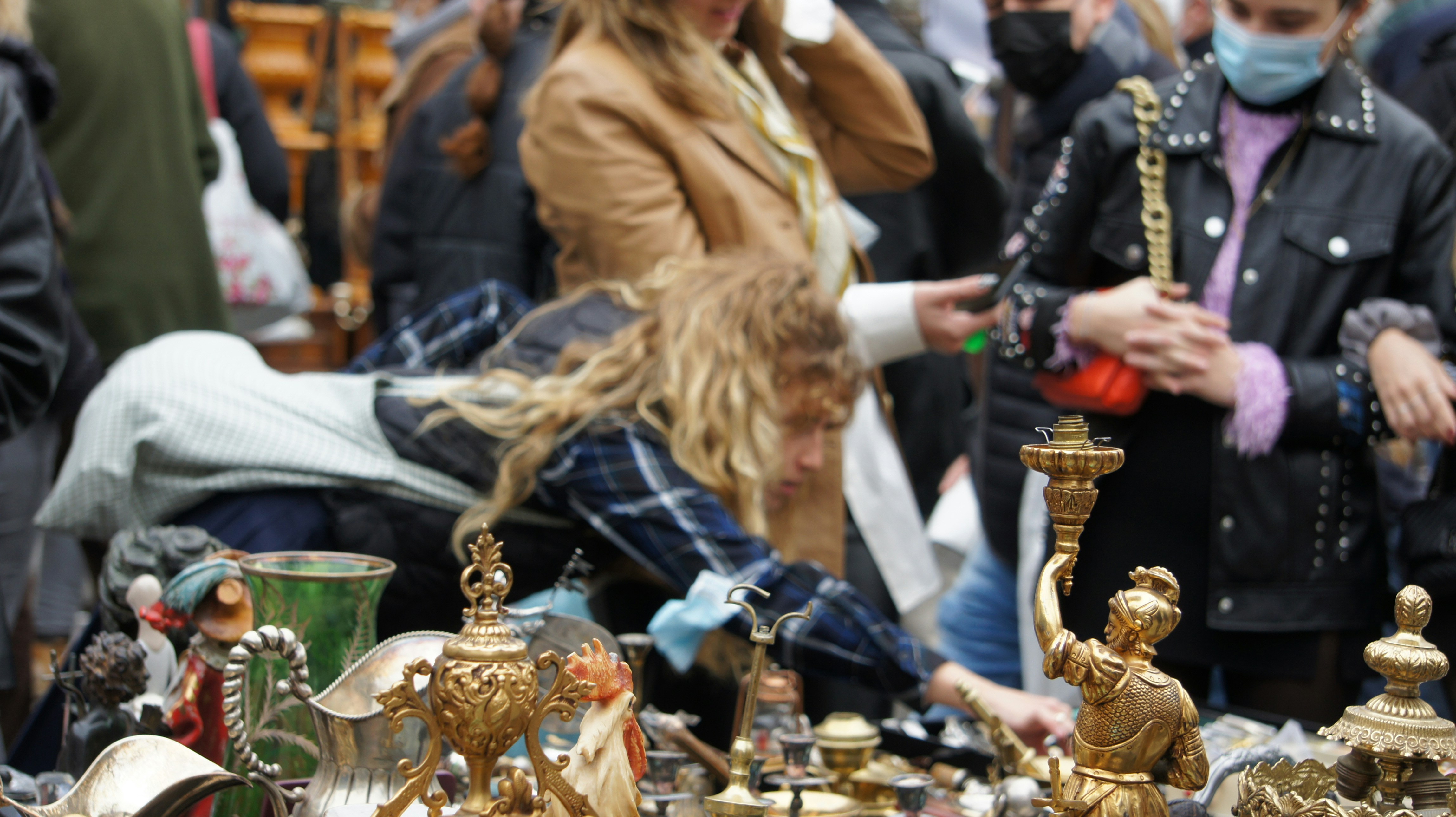 a group of people standing around a table filled with figurines
