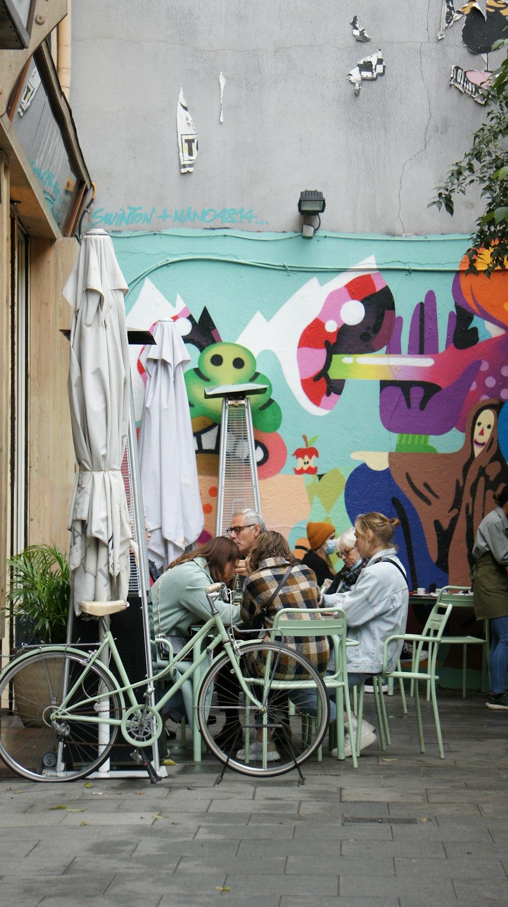 a group of people sitting at a table in front of a building