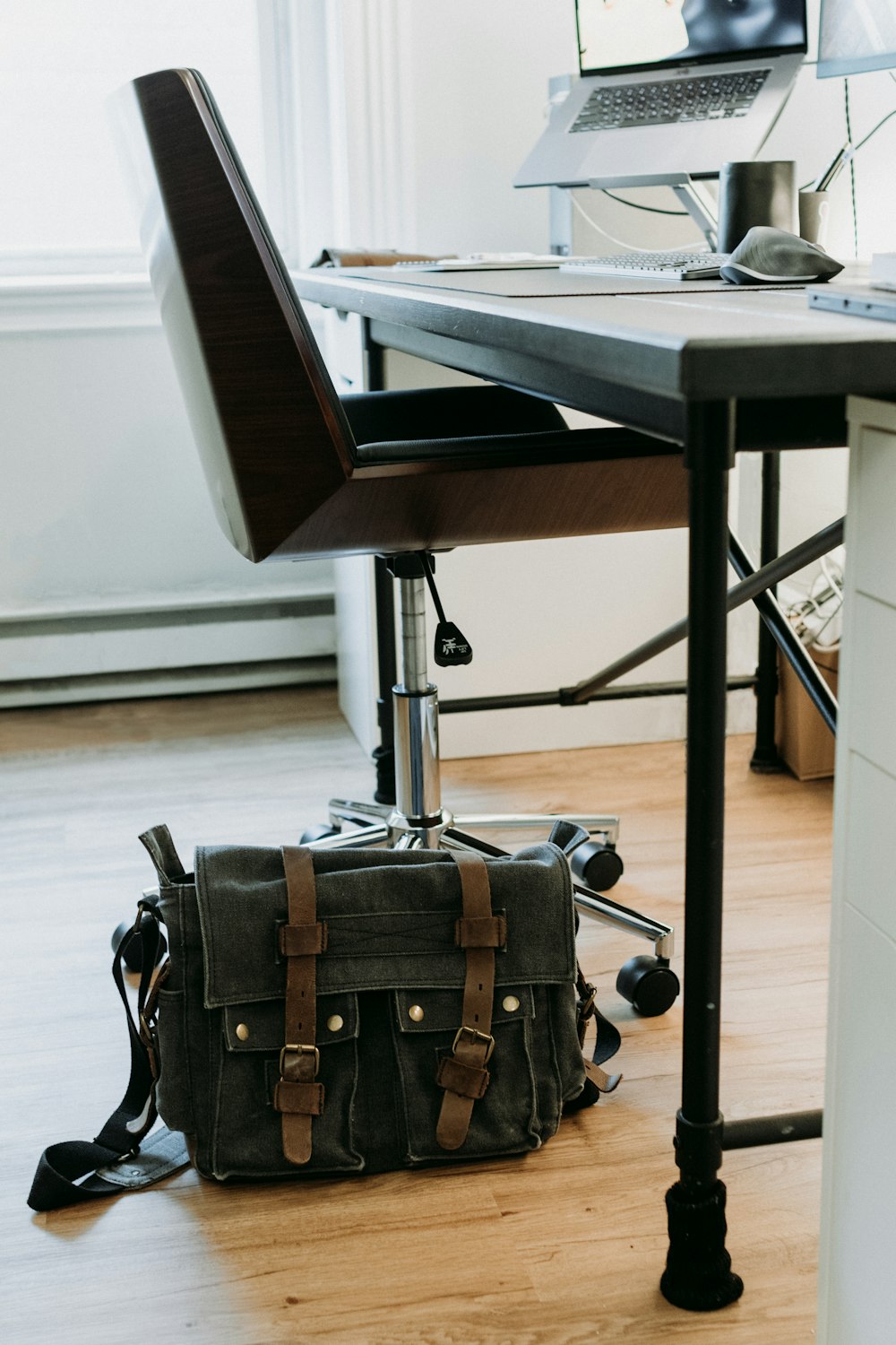 a bag sitting on the floor in front of a desk