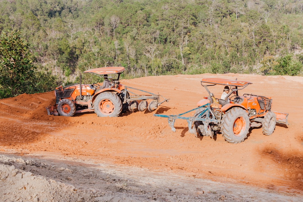 a couple of tractors that are sitting in the dirt