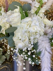 A rustic bouquet featuring white daisies and soft blue hydrangeas.