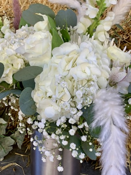 A rustic bouquet featuring white daisies and soft blue hydrangeas.