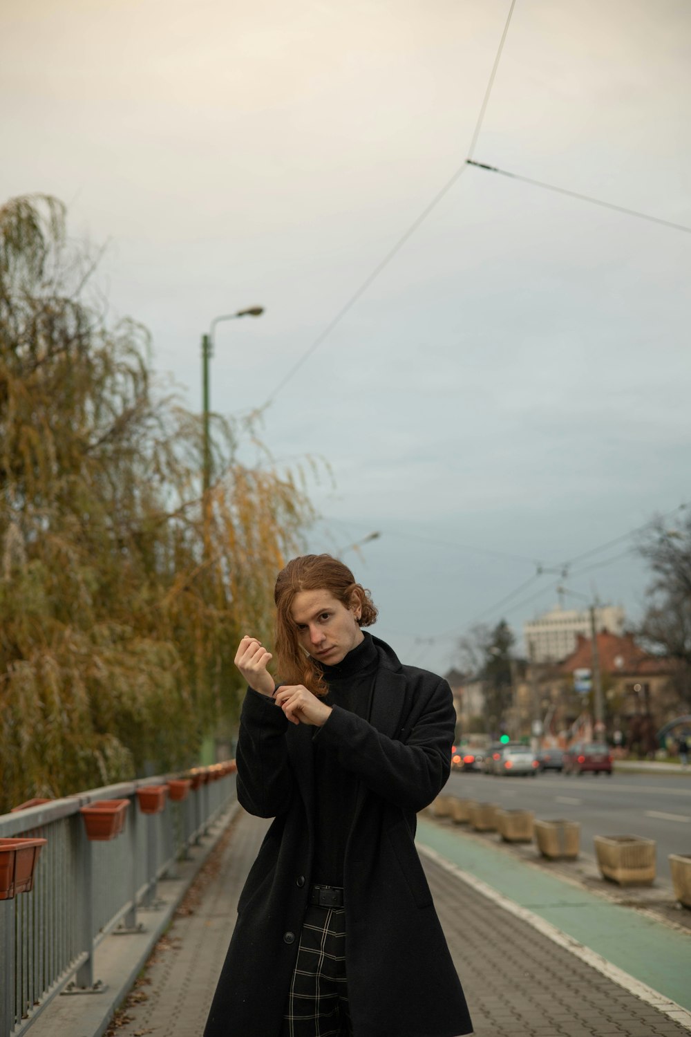 a woman standing on a bridge with her arms crossed