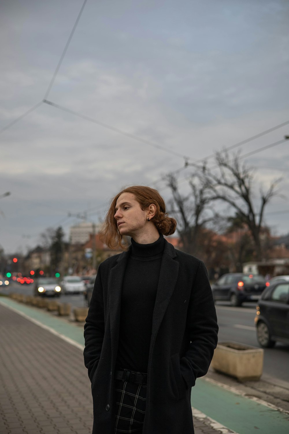 a woman standing on the side of a road