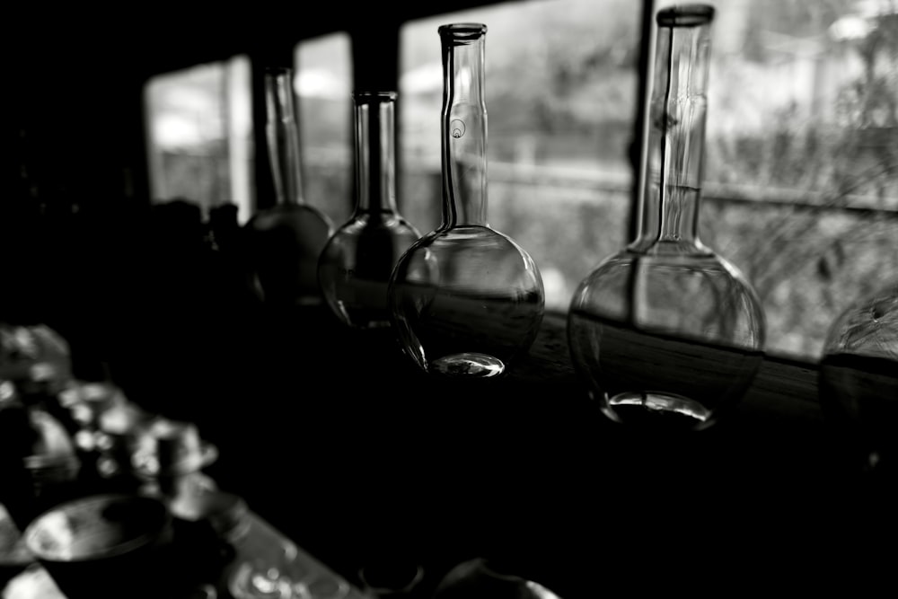 a row of wine glasses sitting on a shelf