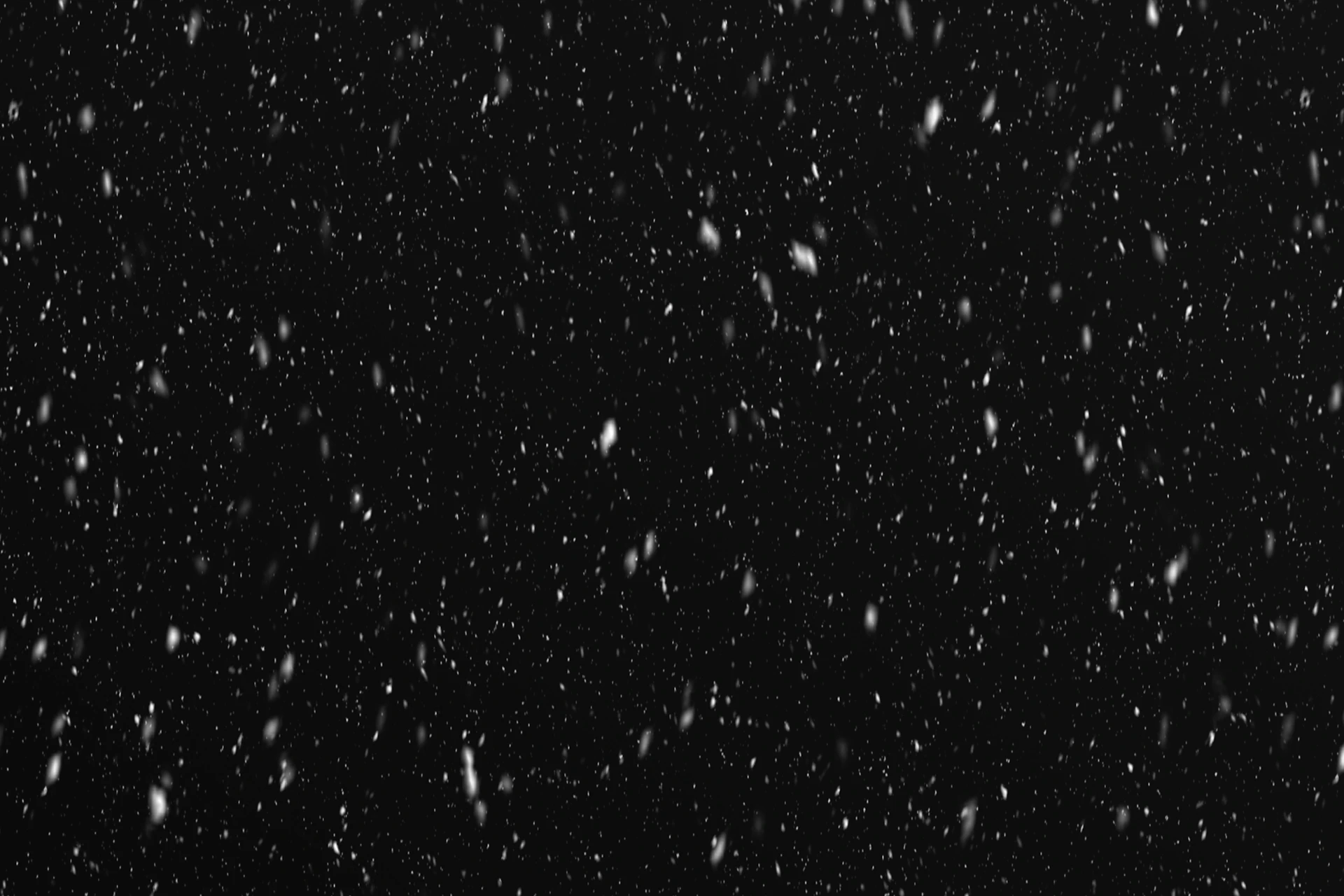 a black and white photo of snow falling
