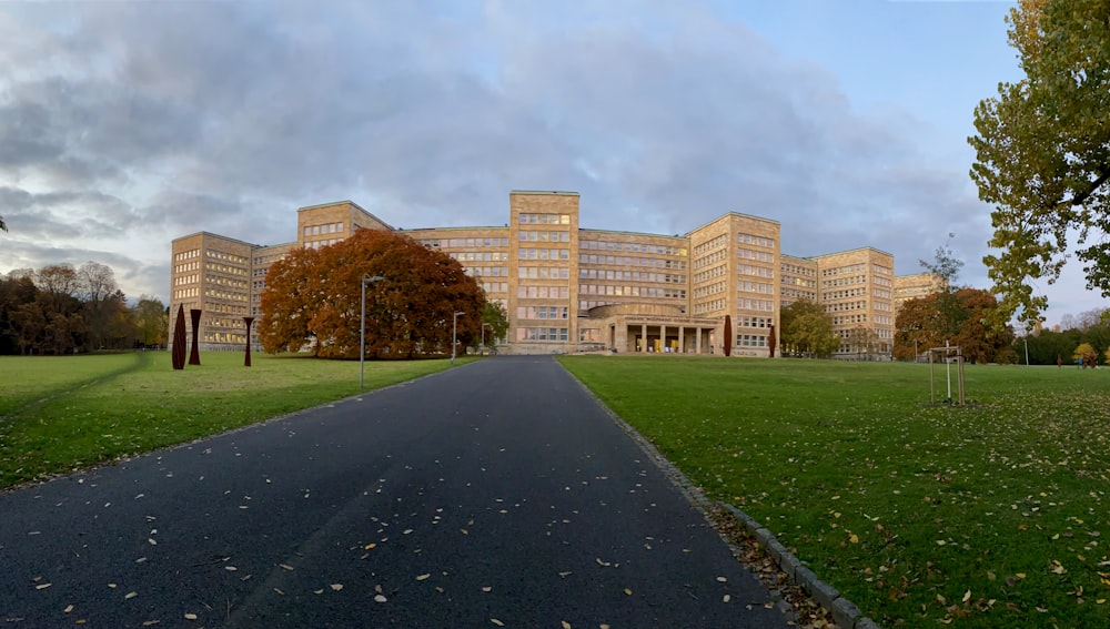 a large building sitting on top of a lush green field