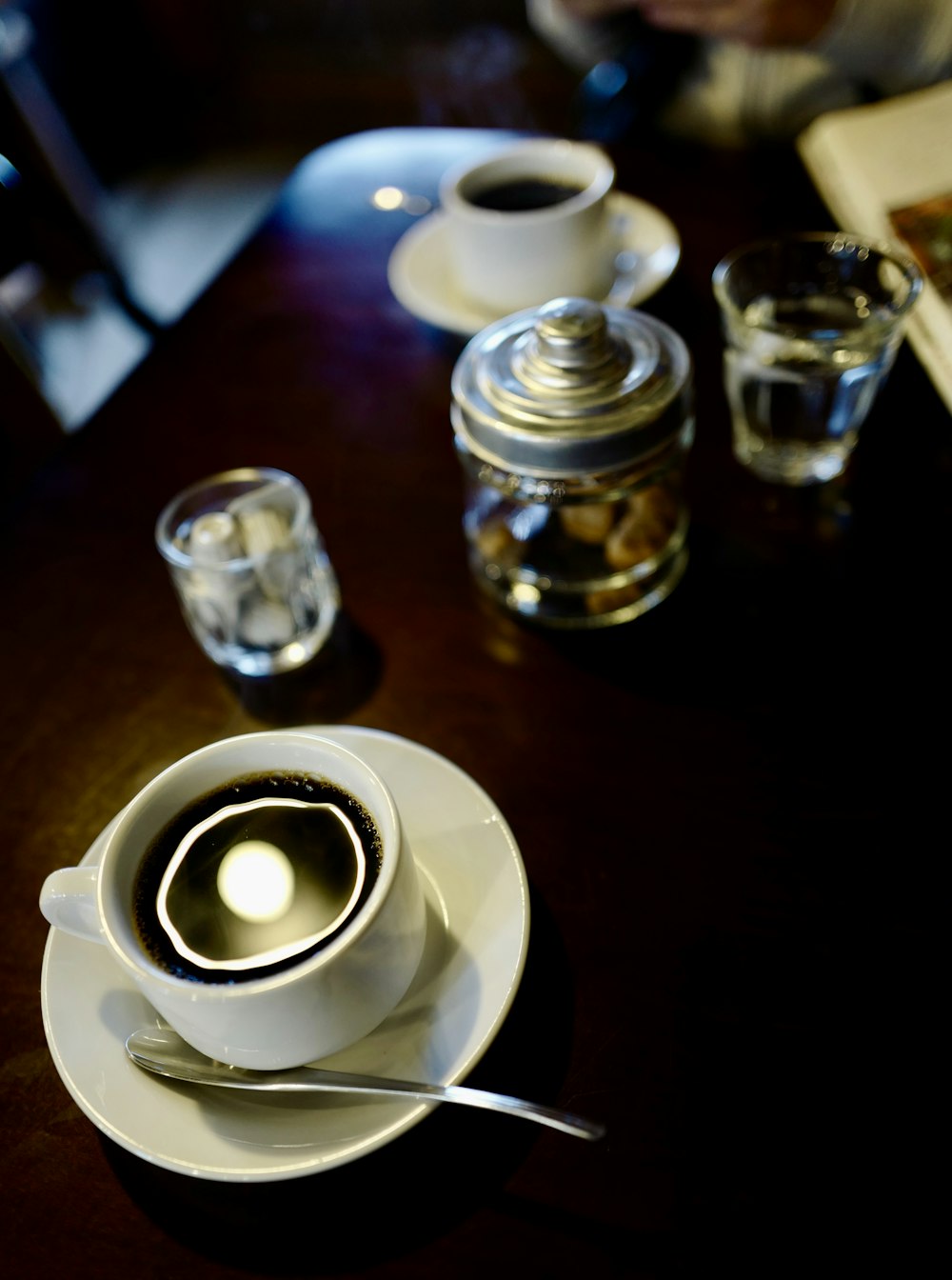 a cup of coffee sitting on top of a table