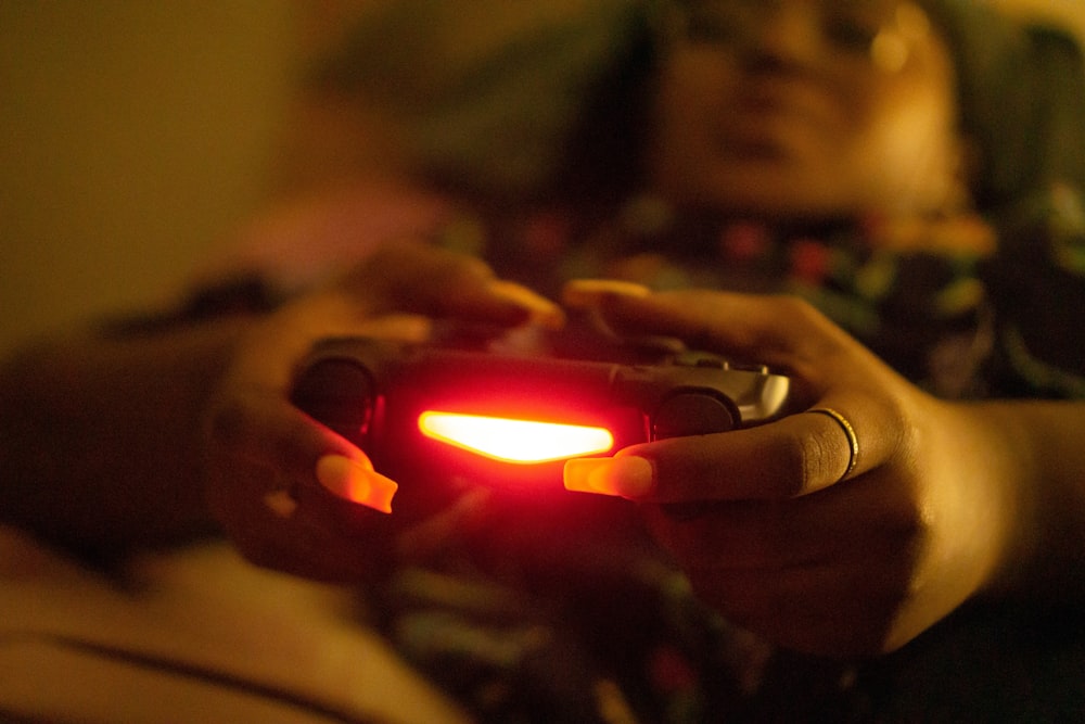 a close up of a person holding a game controller