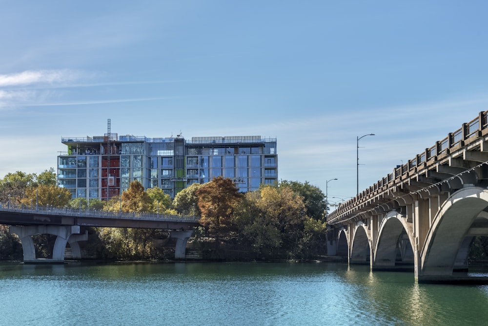 a bridge over a body of water with buildings in the background