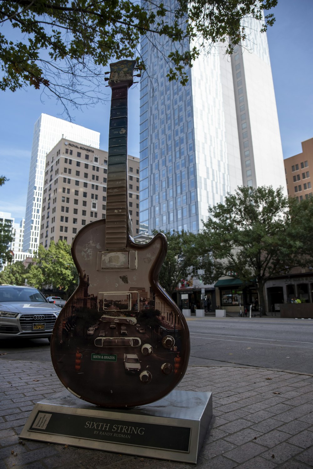 a guitar is on display on a city street