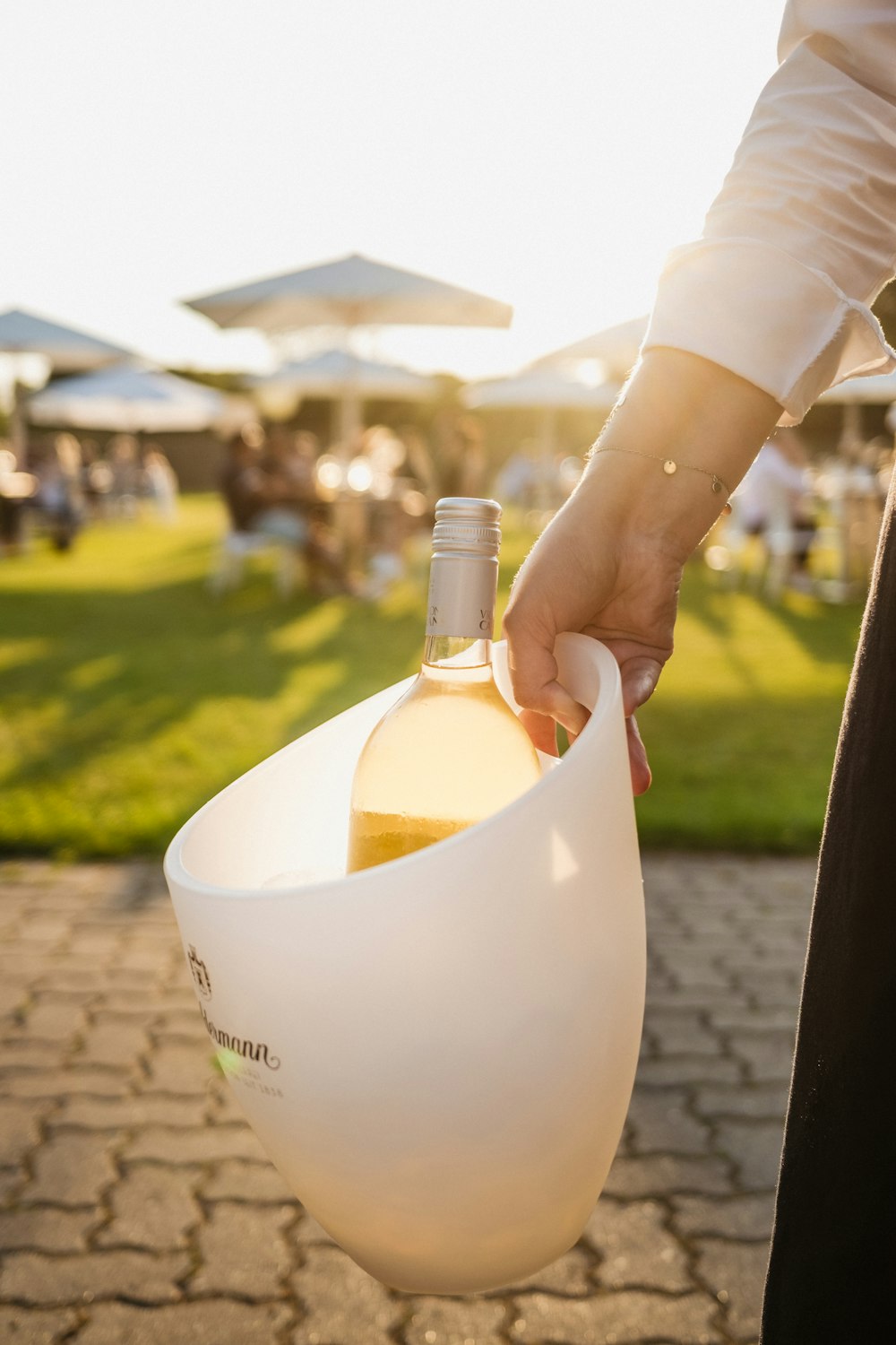 a person holding a bottle of wine in a bag
