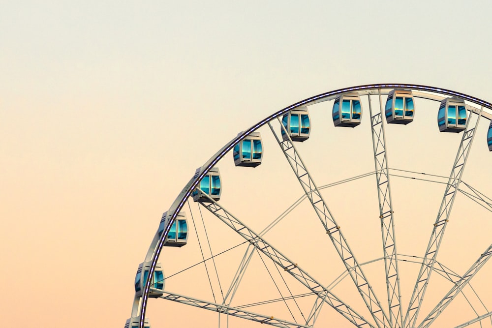 a ferris wheel with blue lights on top of it