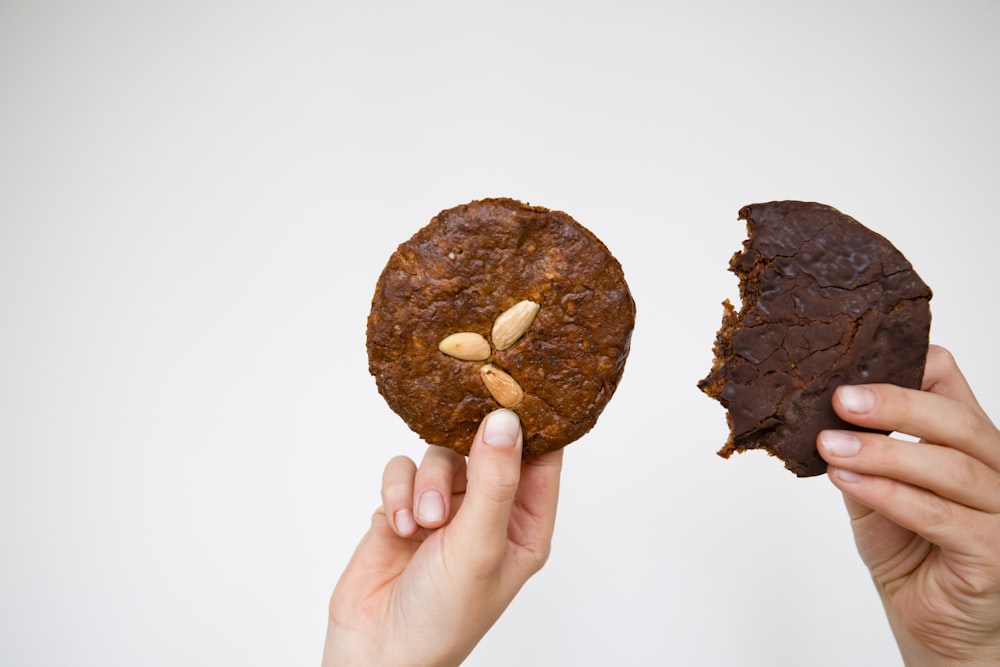 a person holding a piece of food in their hands