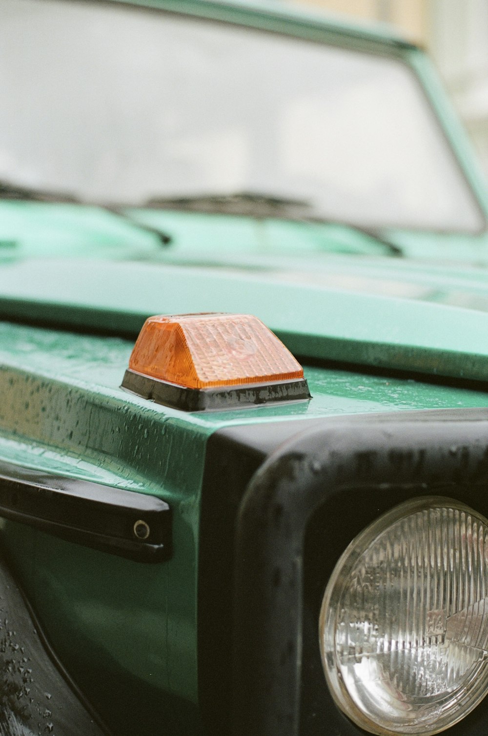 a close up of the front of a green truck