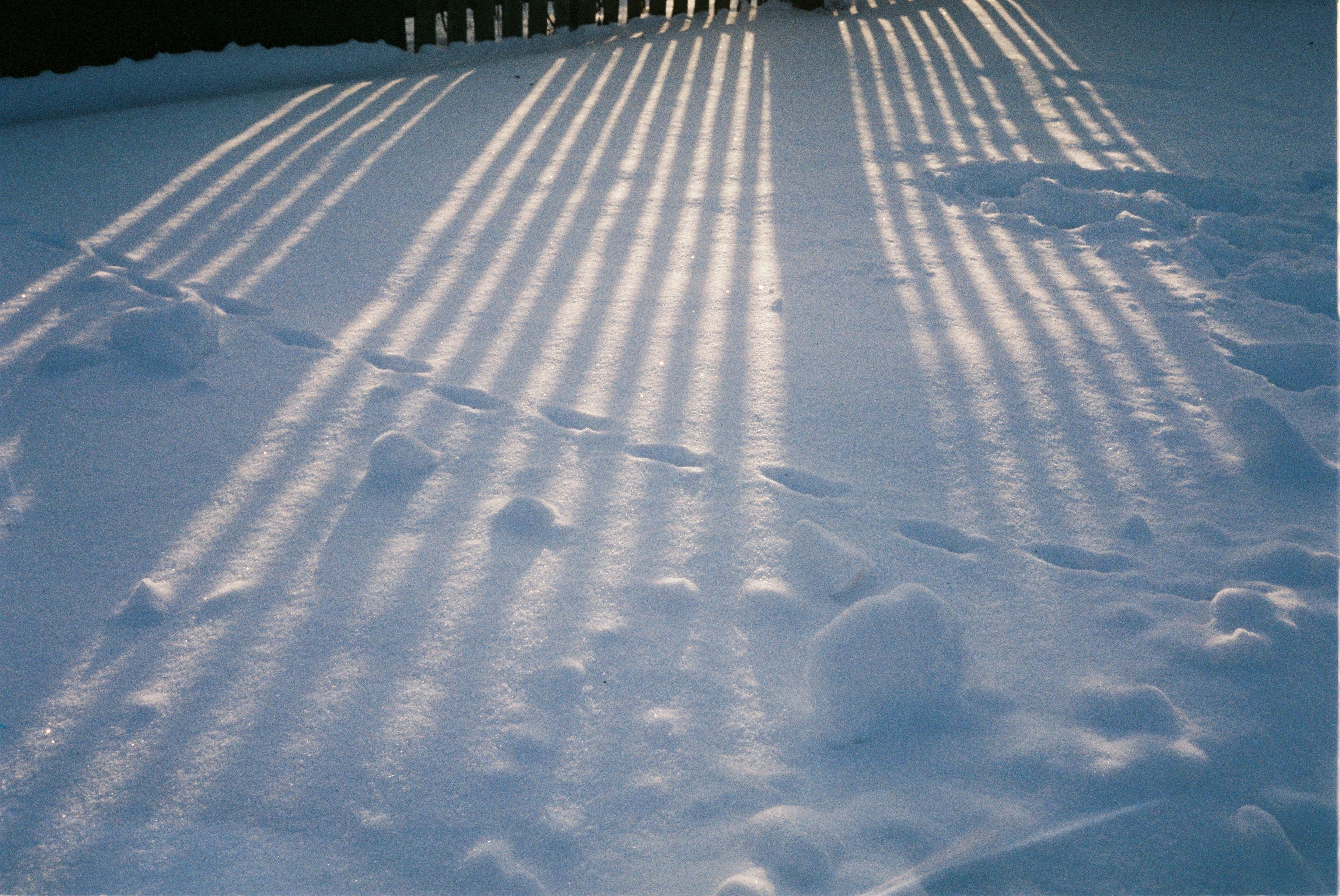 a person riding a snowboard down a snow covered slope