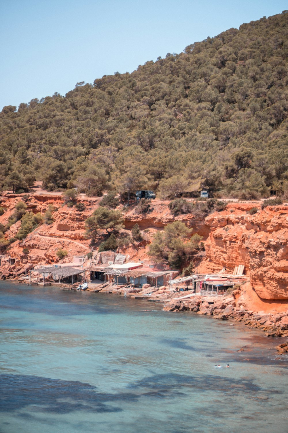 a body of water surrounded by a rocky hillside