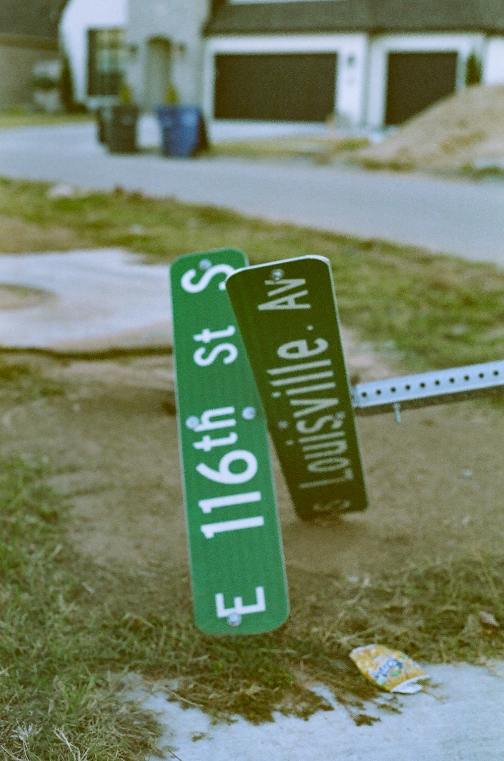 a street sign that has fallen over on the ground
