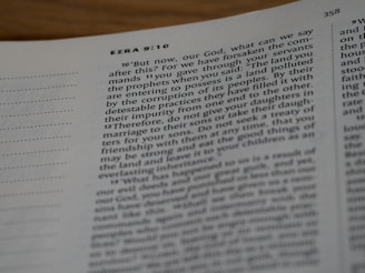 An open page of a Bible with visible chapter and verse numbers. The passage features text from the book of Ezra, specifically chapter 9, verses 10 to 12, running across two columns on white paper.