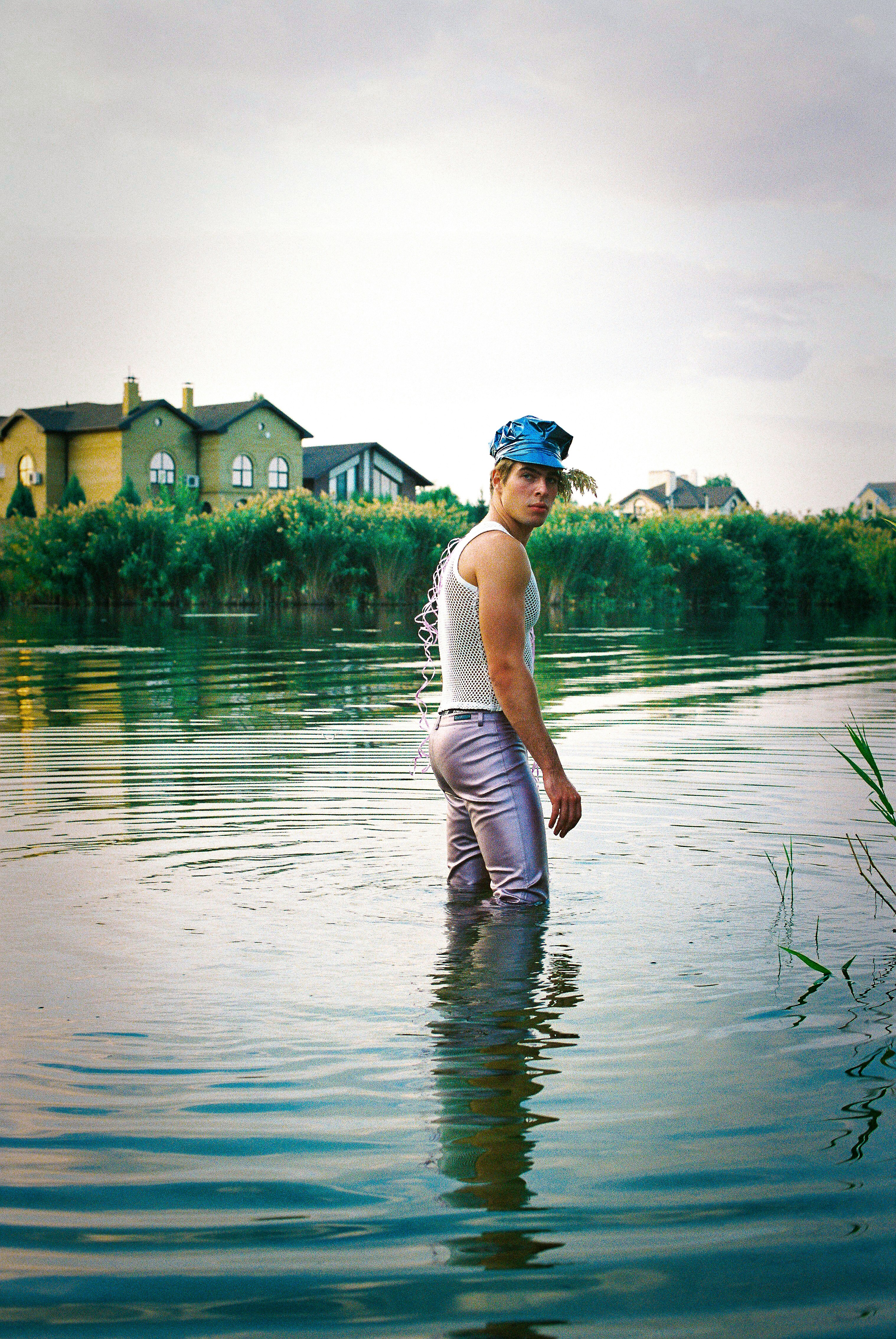 a man standing in the middle of a body of water