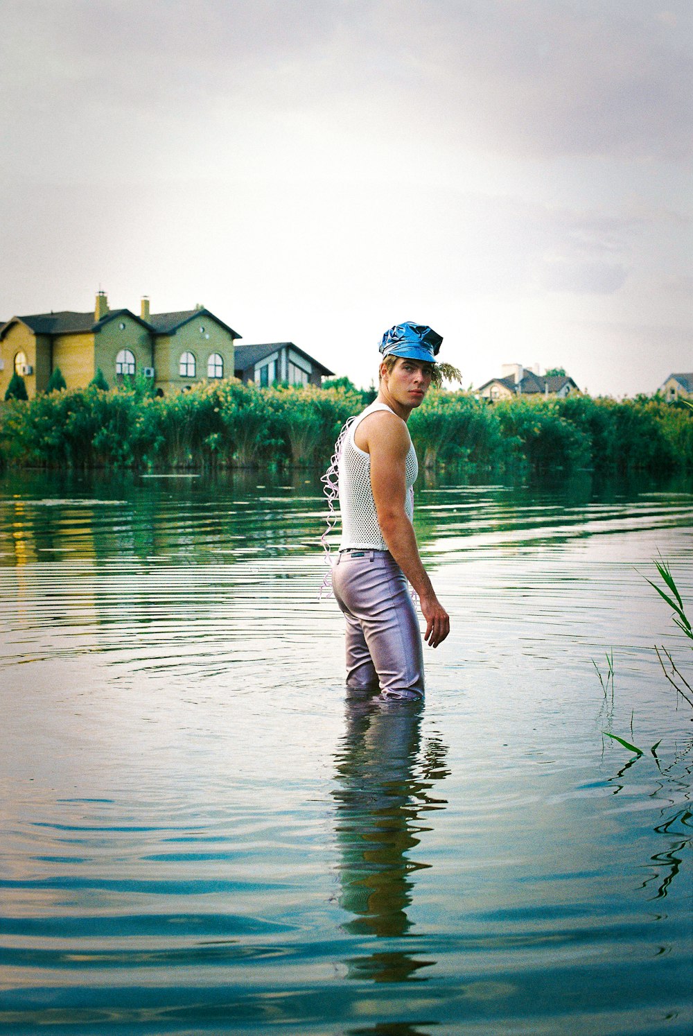 a man standing in the middle of a body of water