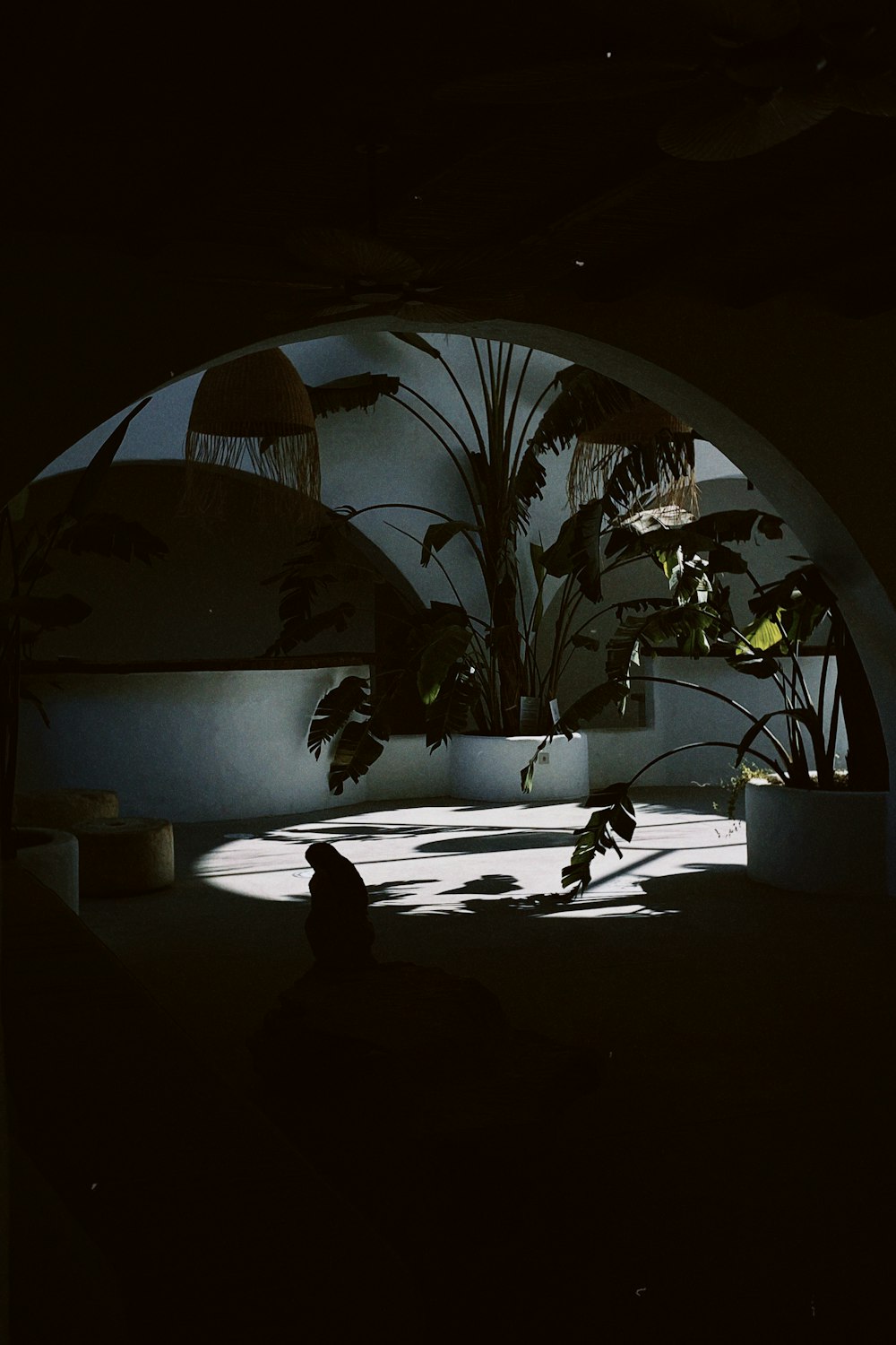 a person sitting on a bench in a dark room