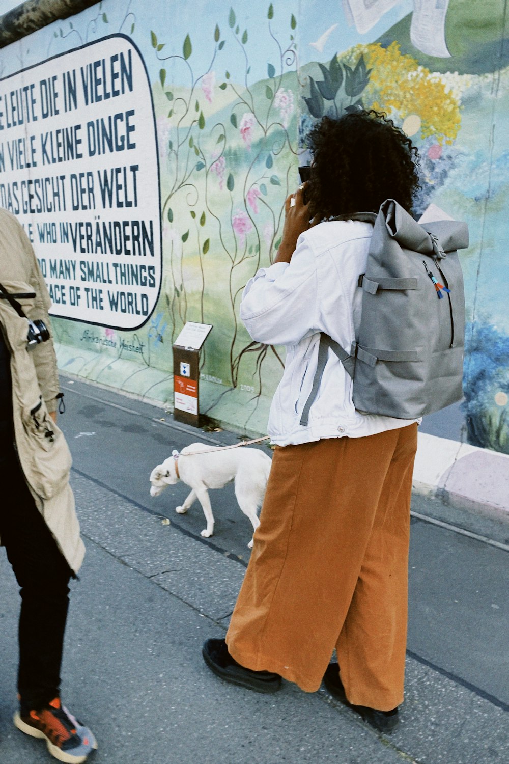 a woman walking down a street while talking on a cell phone