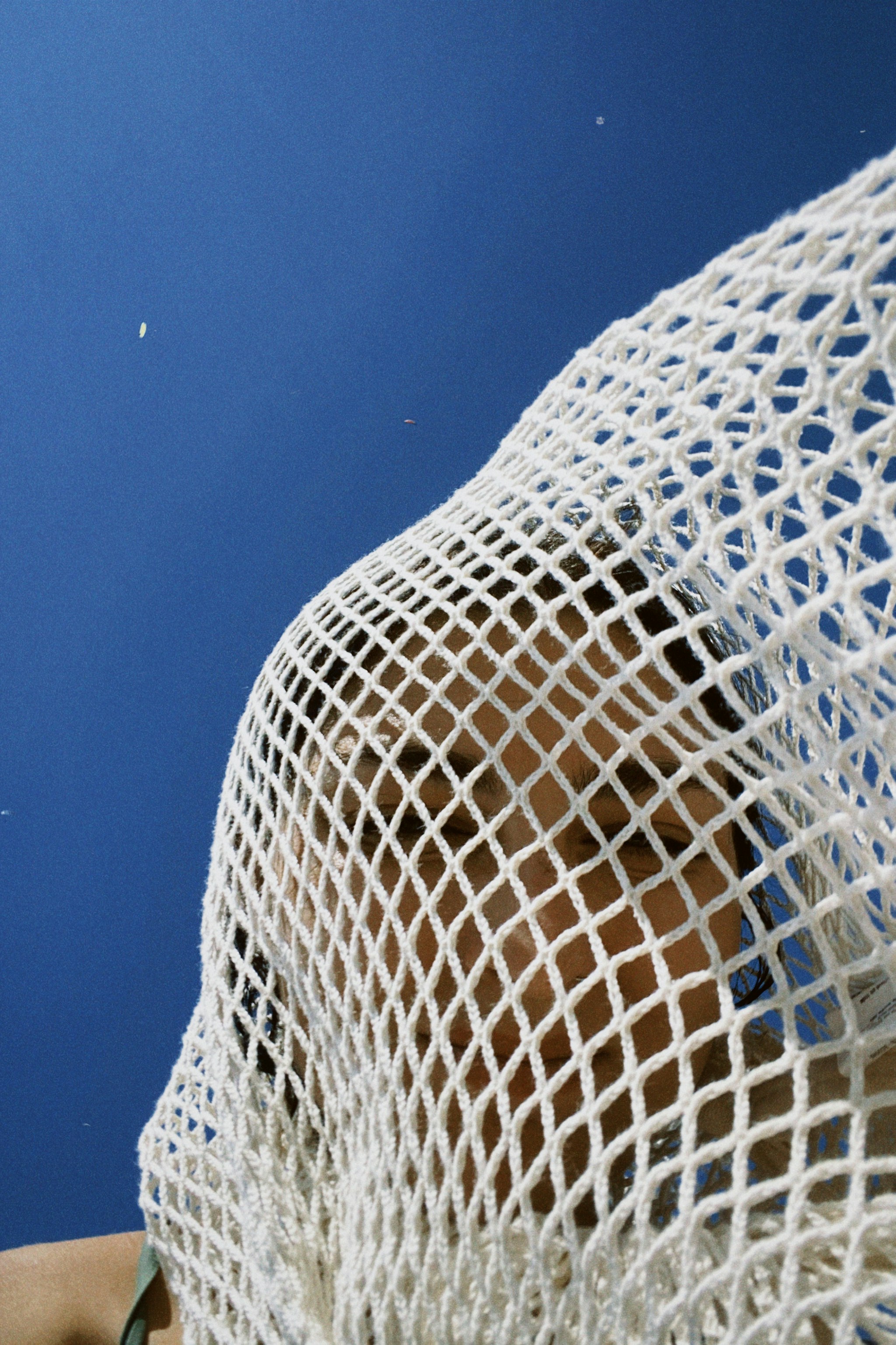 a close up of a white net on a blue background