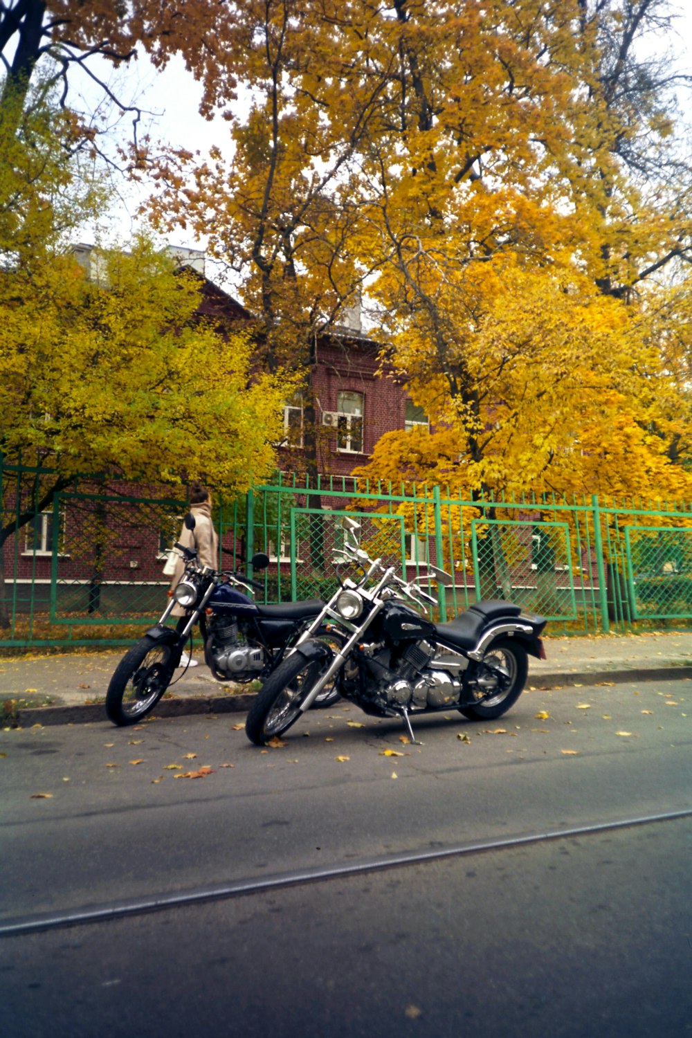 two motorcycles parked on the side of the road