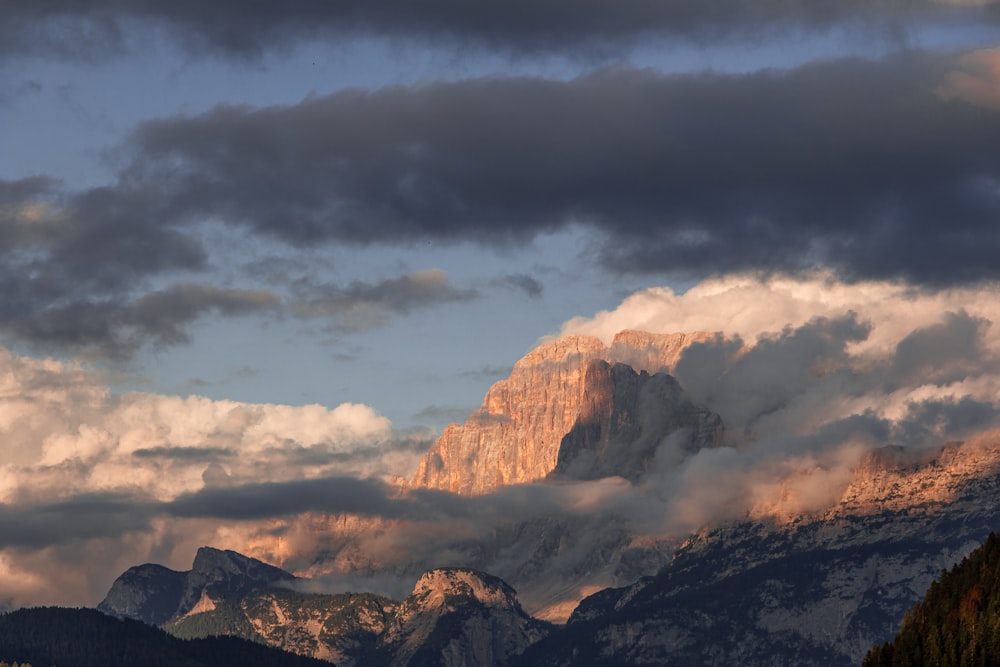 a view of a mountain range with clouds in the sky