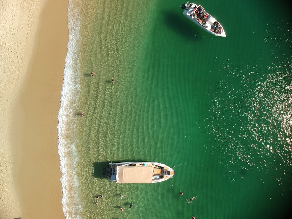 a couple of boats floating on top of a body of water