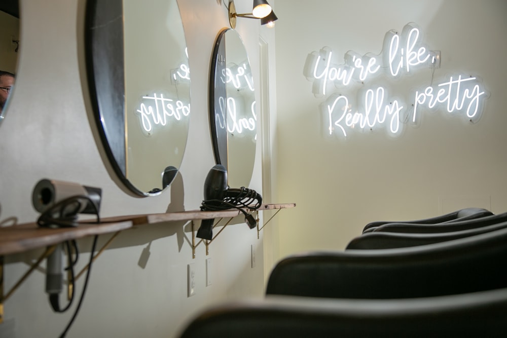 a hair salon with chairs and neon signs
