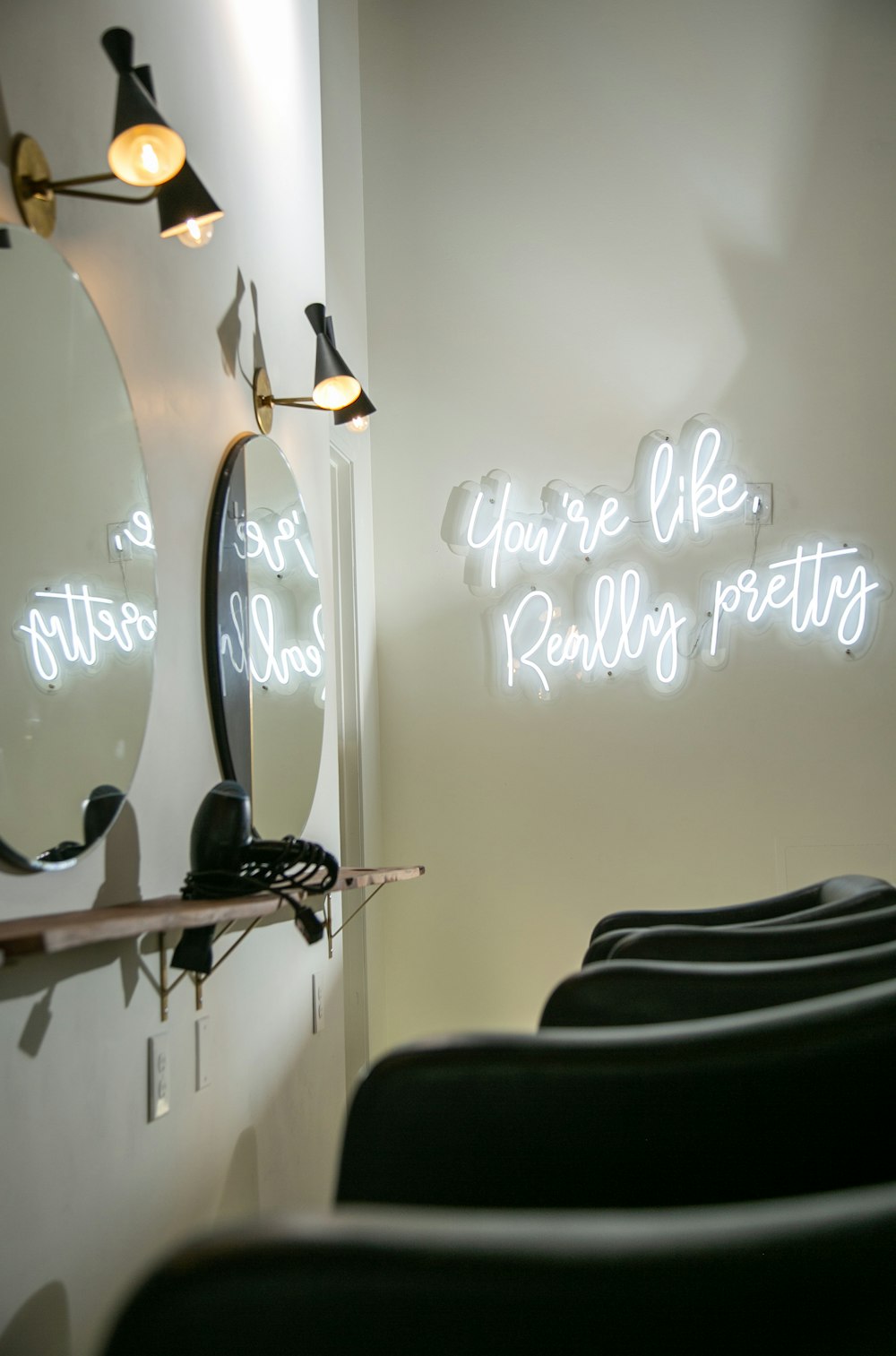 a hair salon with chairs and a mirror