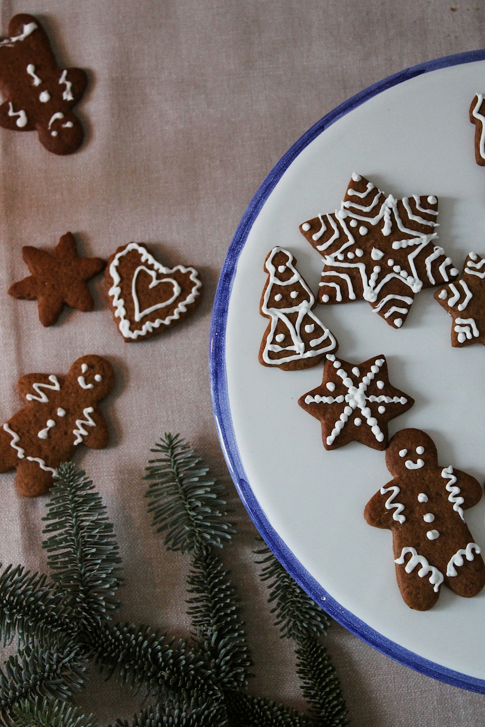 a white plate topped with cut out ginger cookies