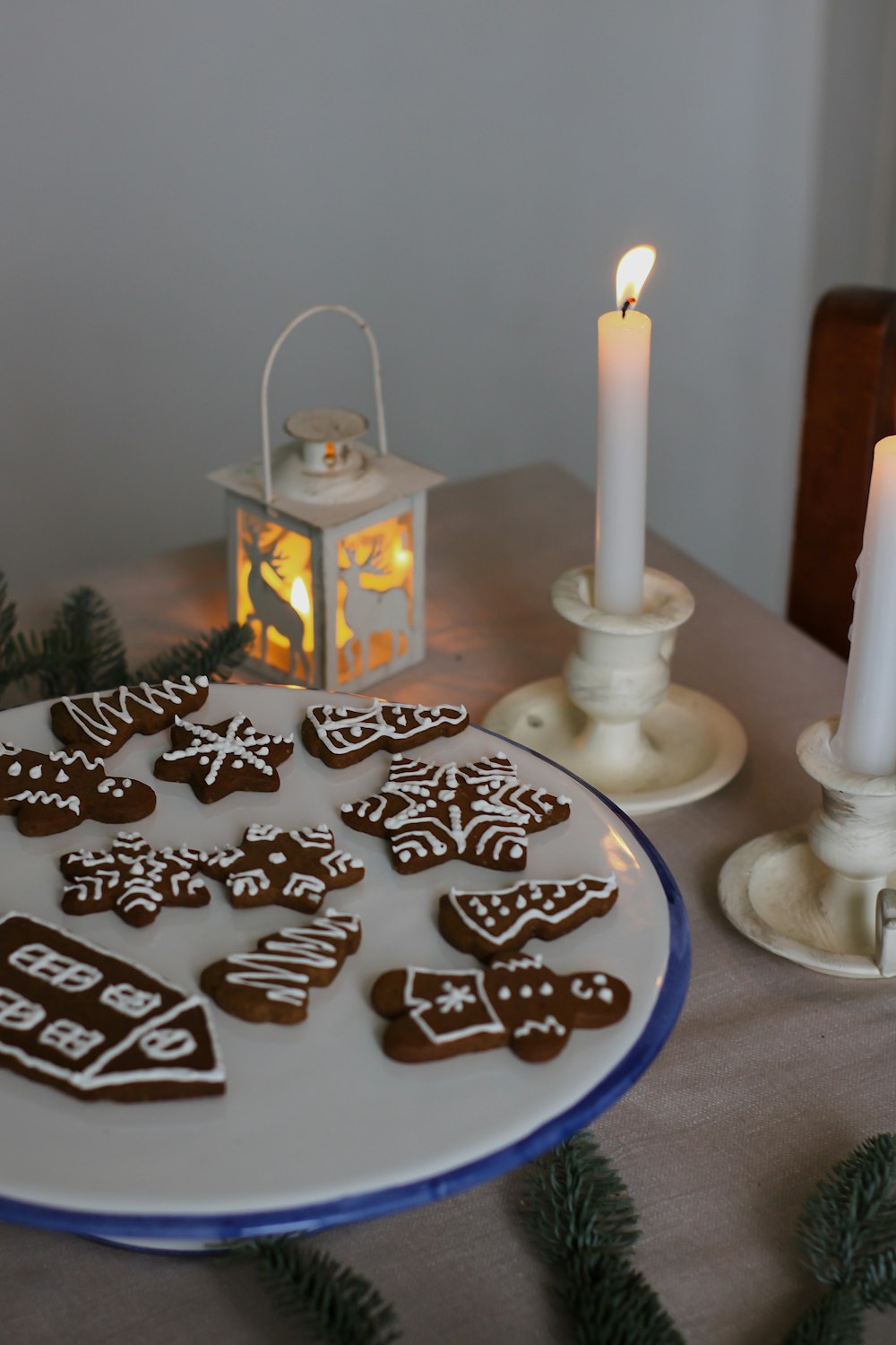 a plate of cookies on a table with a lit candle