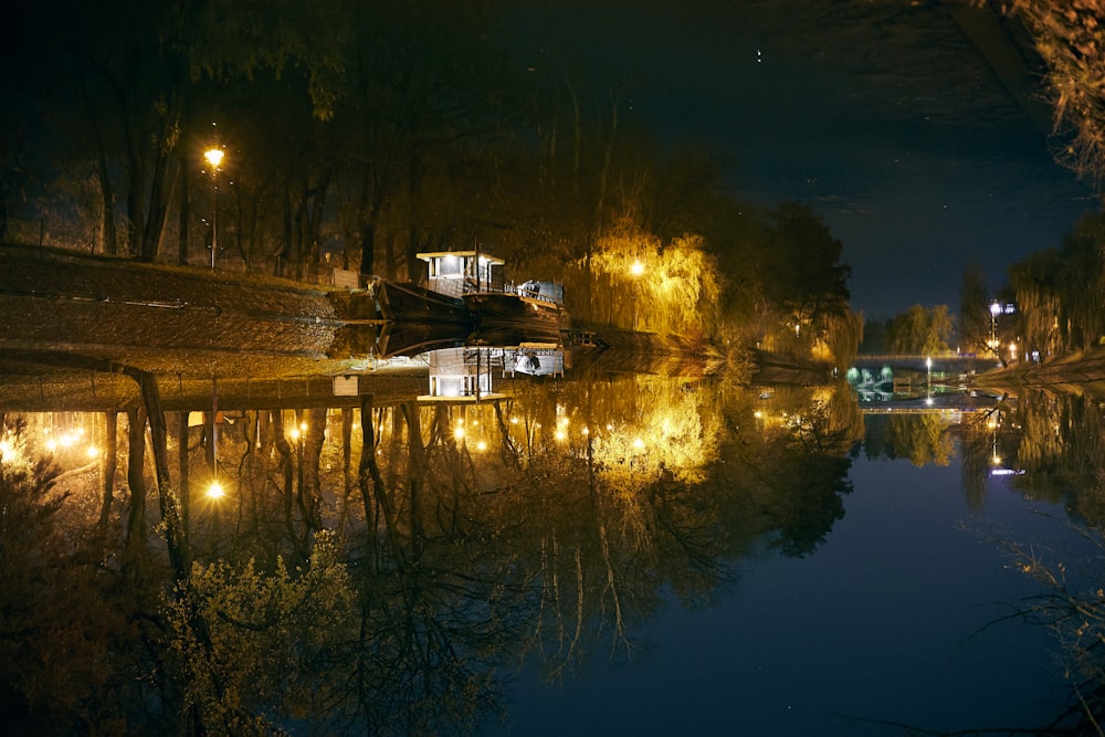 a river at night with lights reflecting in the water